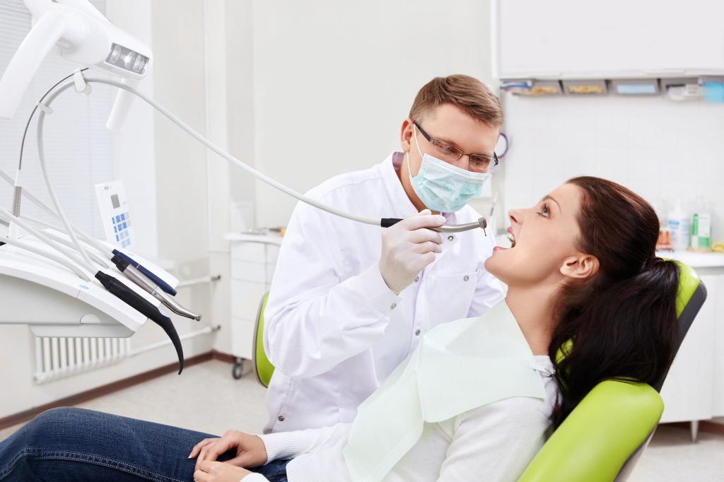 the dentist treats teeth of patient.jpg